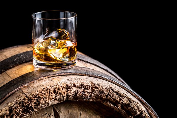 Whisky glass on a barrel